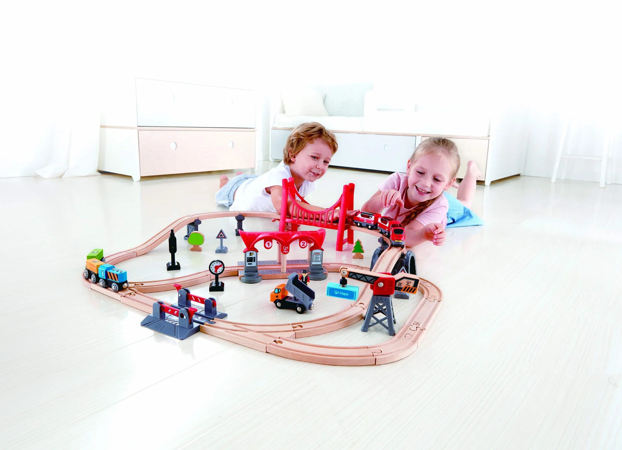 Hape Busy City Train Rail Set, Complete City-Themed Wooden Rail Toy Set for Toddlers with Passenger Train, Freight Train, Station, Play Figurines and More